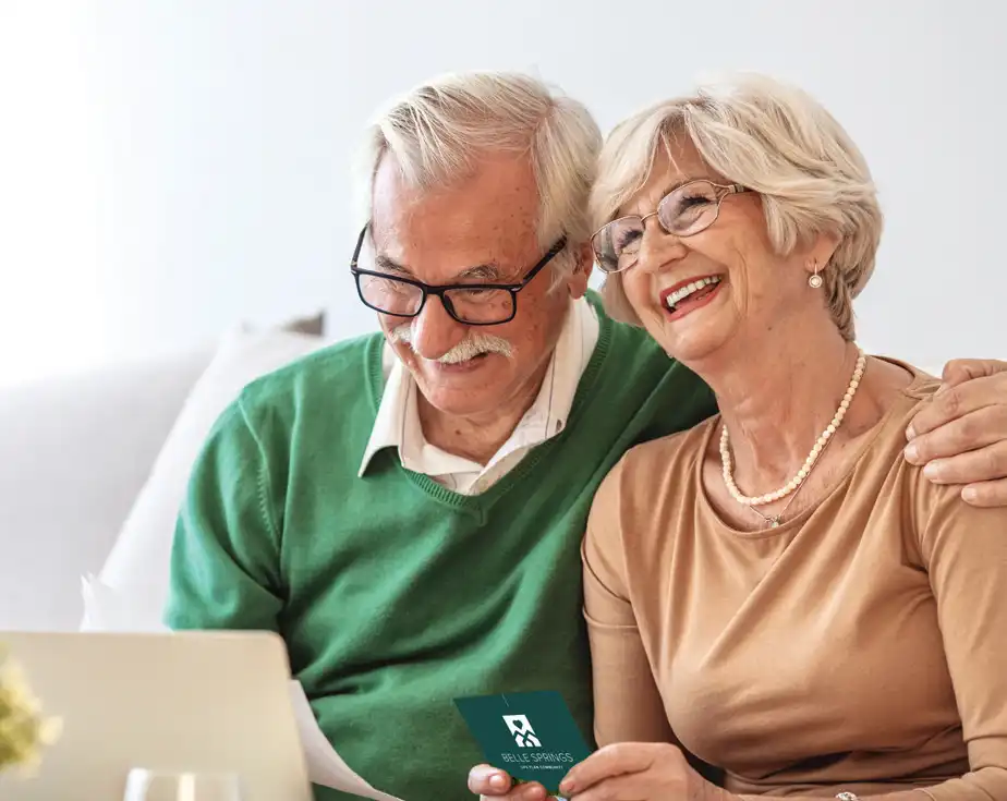 Couple smiling on their laptop