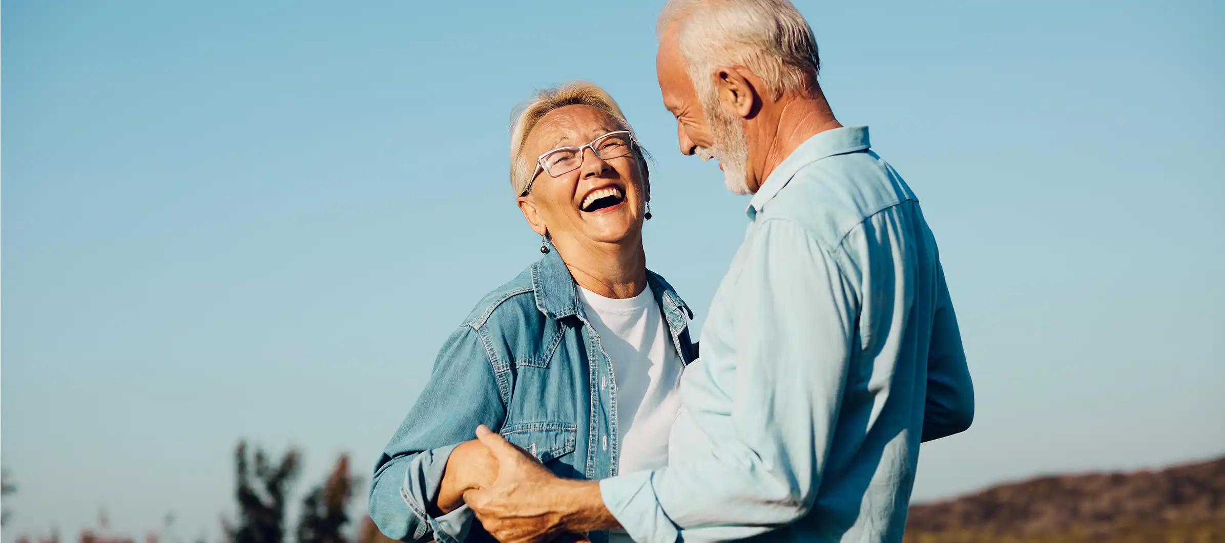 Happy couple holding hands outdoors
