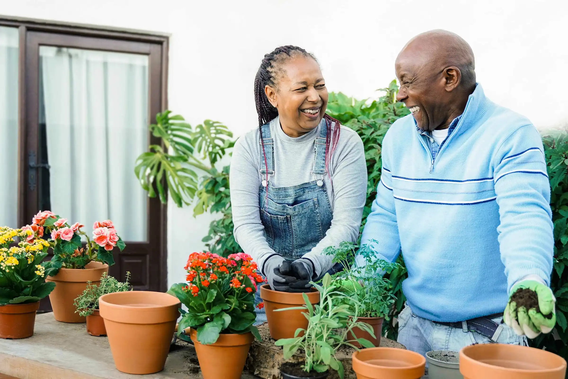 Couple gardening with potted plants